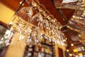 WineÃ¢â¬â¢s glasses are perfectly clean hanging on the bar counter.